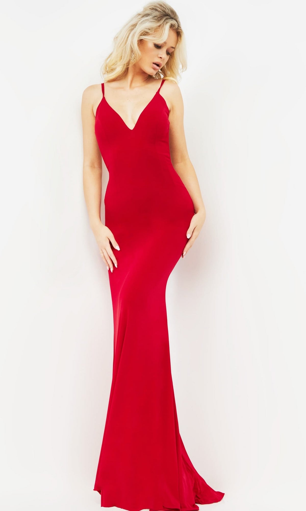 Woman models the Jovani Strappy-Back Long Jersey Prom Dress 00512, featuring a fitted silhouette, sleeveless design, deep V-neckline, and strappy-back detail against a plain white background.